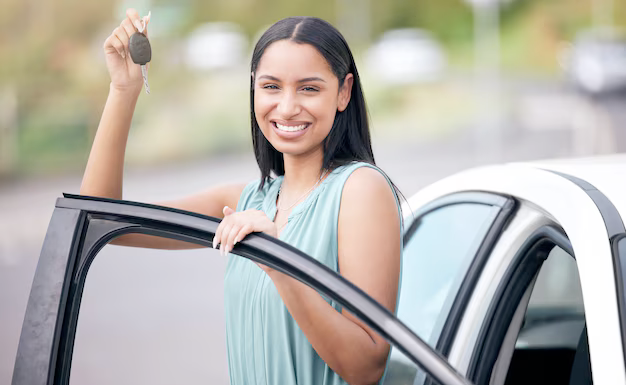 a person smiling in front of a modern car, representing savings on auto insurance.